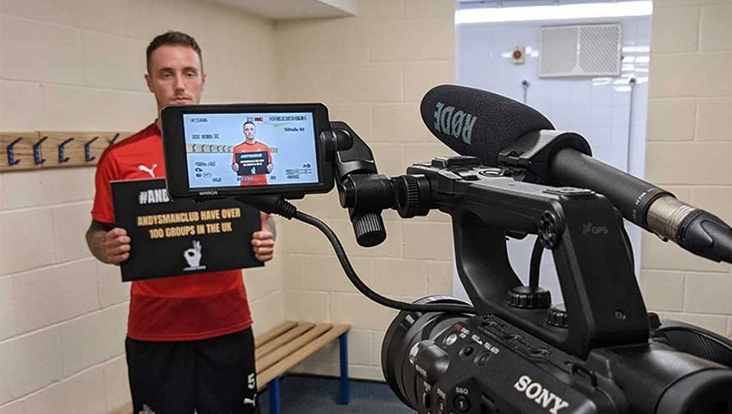 Shot of a man standing before a camera, recording a promotional video. Shot of a man standing before a camera, recording a promotional video.
